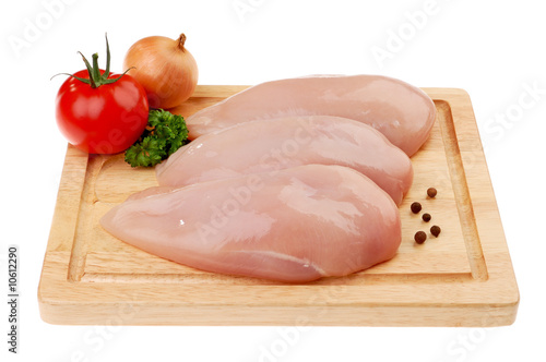 Raw chicken breasts isolated on white photo