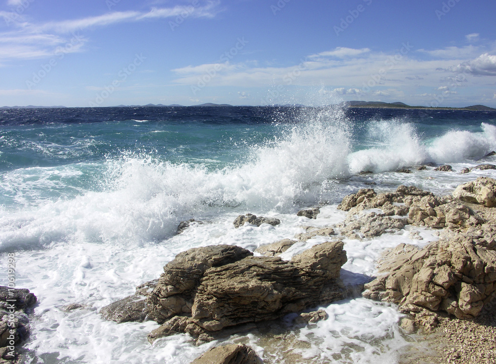 Impact of large waves against rocks in the beach