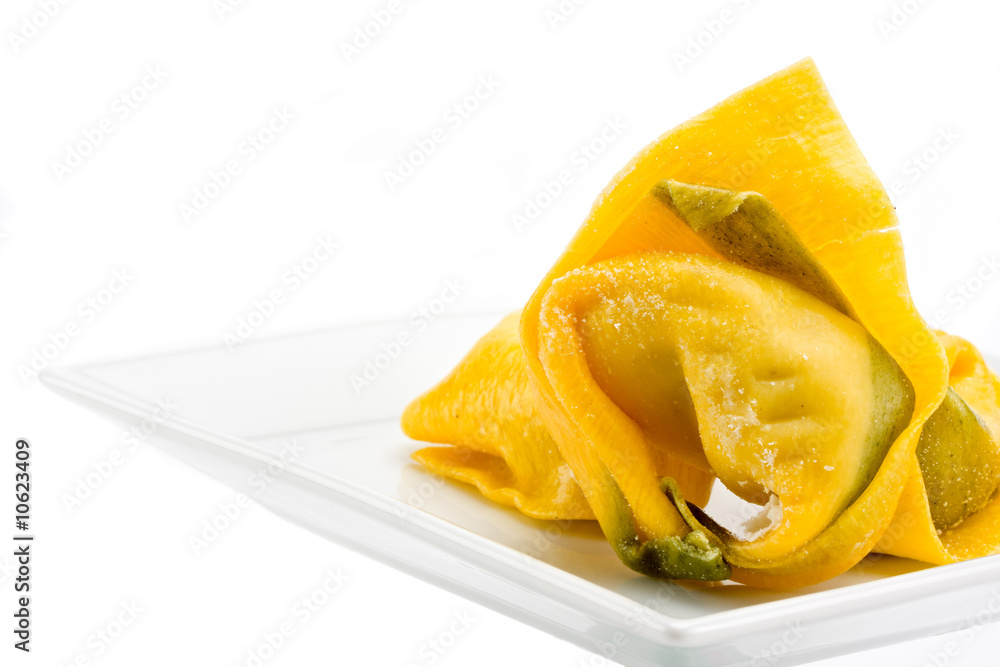 single tortelloni noodle on a white plate single tortelloni noodle on a white plate