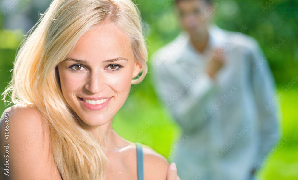 Young woman and looking at woman man on background