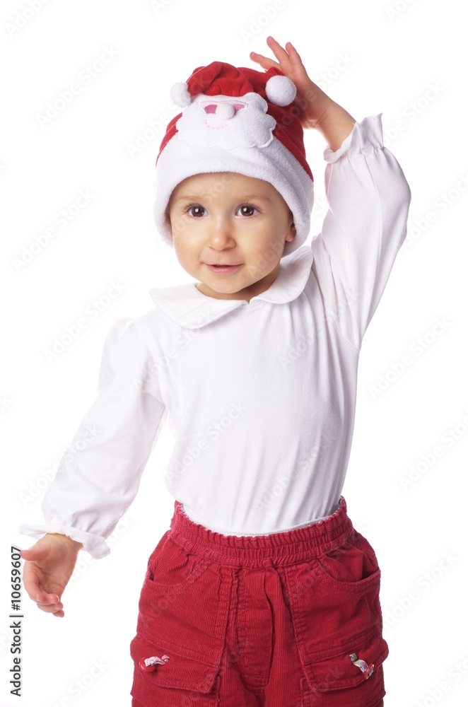 baby in big Santa Claus hat, holding its hand on its head