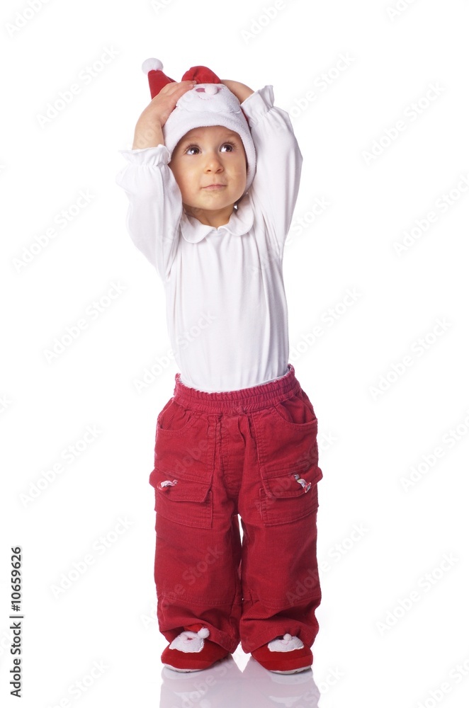 baby in big Santa Claus hat, holding its hand on its head baby in big Santa Claus hat, holding its hand on its head
