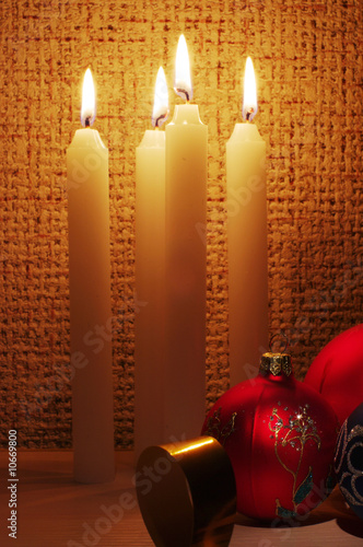 The burning candles, balls and ribbons it are Christmas