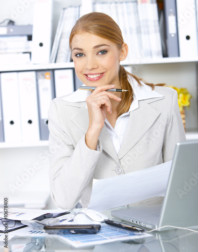 Beautiful business woman working in office, smiling