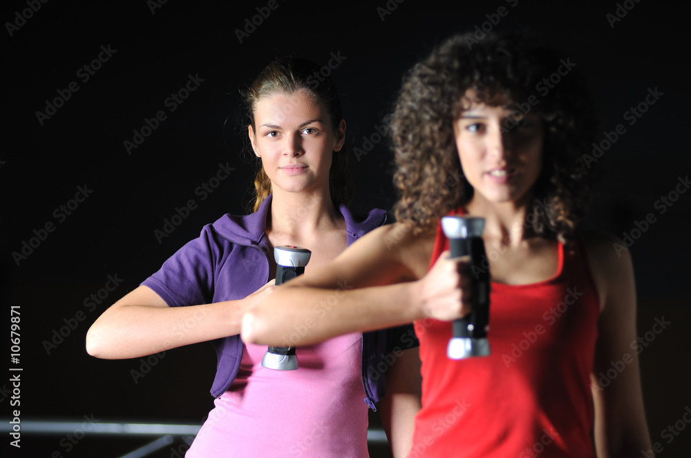 Naklejka premium two girls working out in fitness club