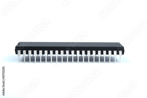 Black integrated circuit with many legs isolated over white.