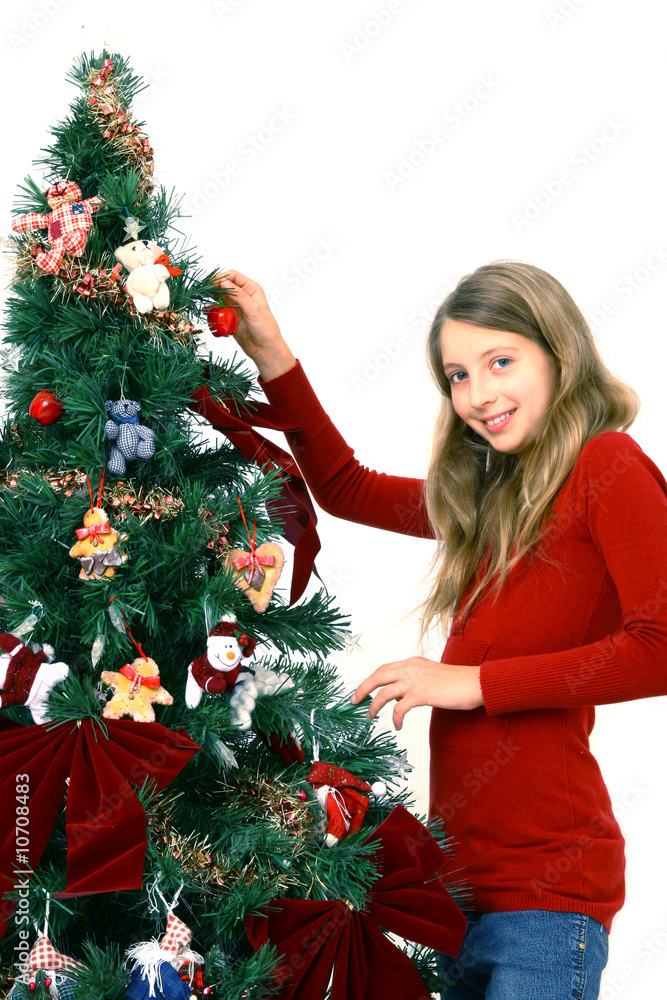 Young girl decorate christmas tree