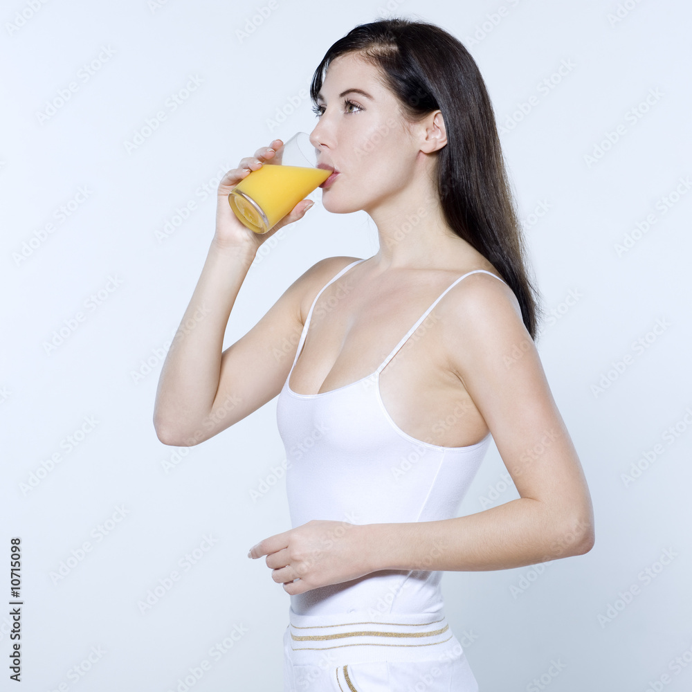 young woman drinking orange juice young woman drinking orange juice