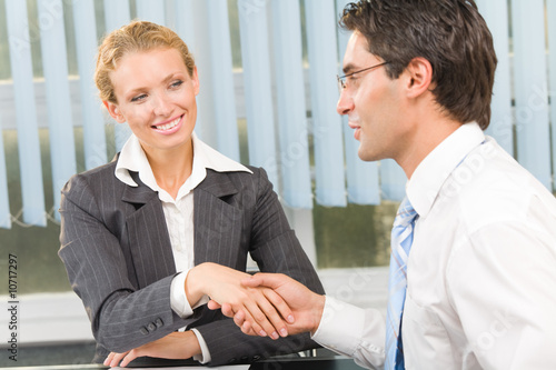 Two businesspeople cheering by handshake or flirting