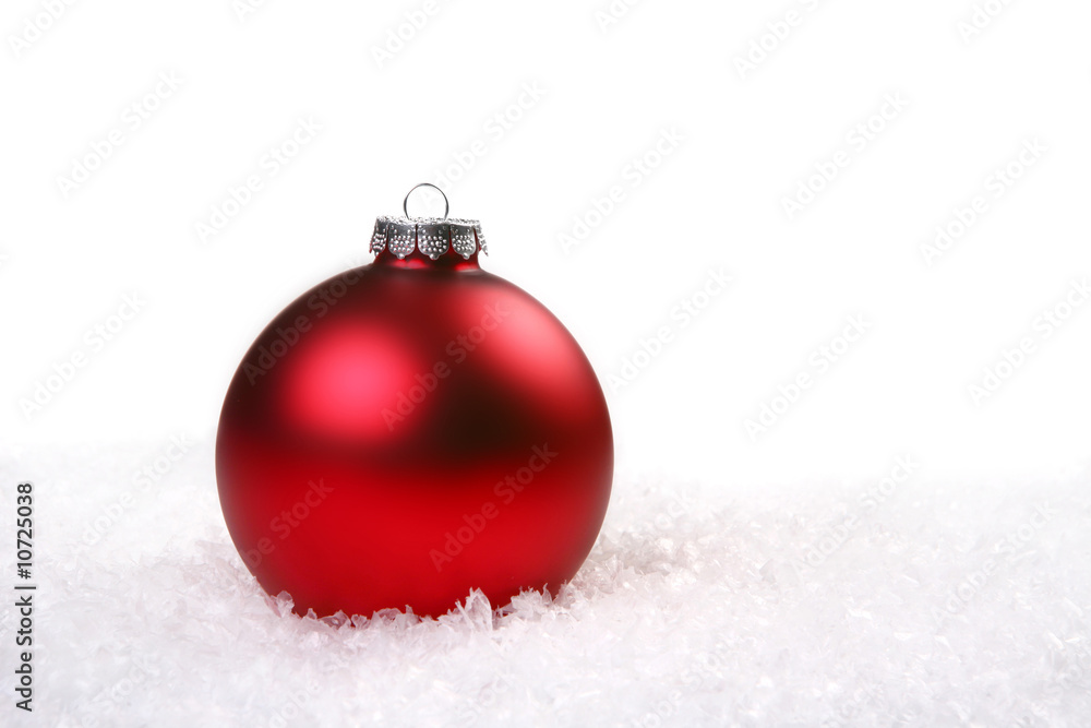 Single Red Shiny Christmas Ornament in the Snow Single Red Shiny Christmas Ornament in the Snow