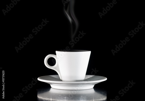 Cup of hot drink with steam over black background