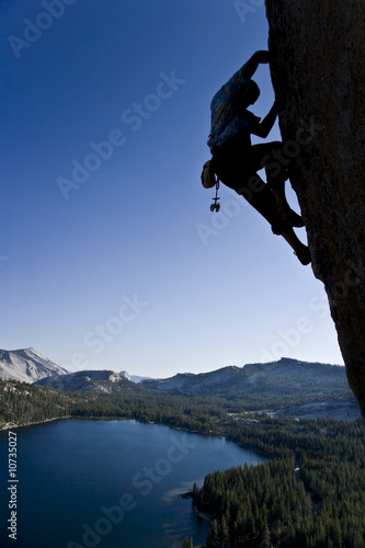 Rock climber clinging to a cliff.