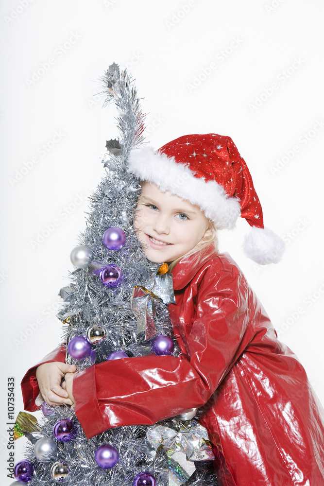 little girl preparing christmas tree