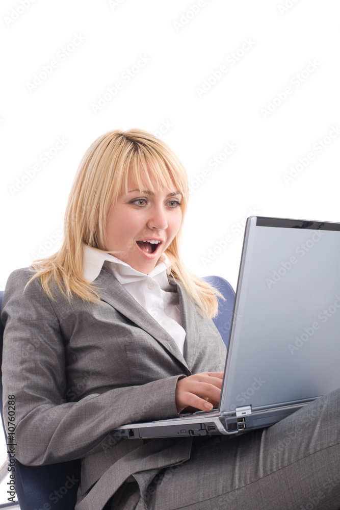 Amazed businesswoman with laptop in chair over white Amazed businesswoman with laptop in chair over white