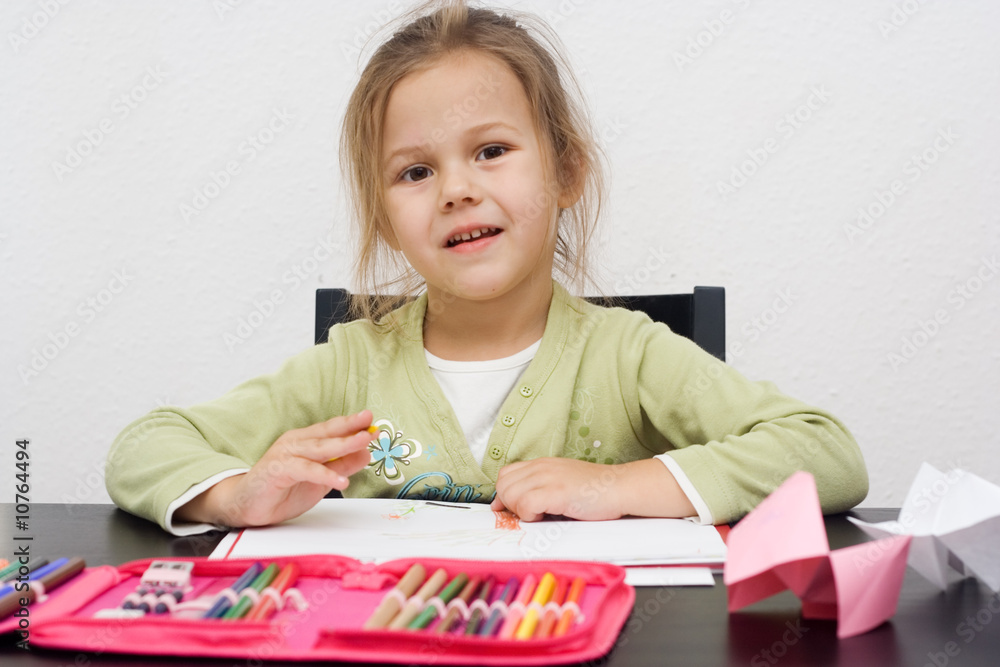 cute little girl drawing a picture on white