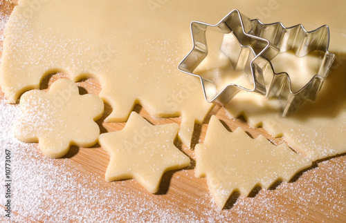 Dough and christmas cookie cutter forms photo