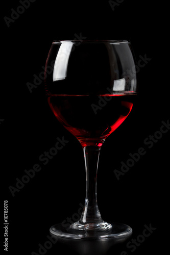 red wine in glass isolated on black background