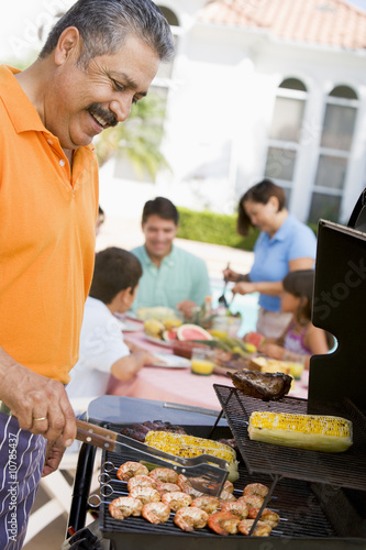 Family Enjoying A Barbeque