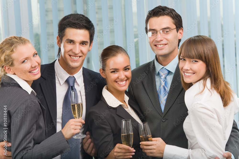 Happy business team celebrating with champagne at office Happy business team celebrating with champagne at office