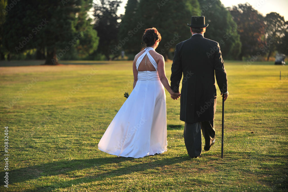 Bride and groom on a sunlit lawn