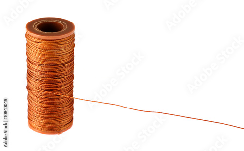 Close-up of the orange strong thread spool isolated on white