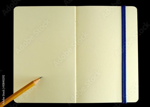Classic opened moleskine note book with penci photo