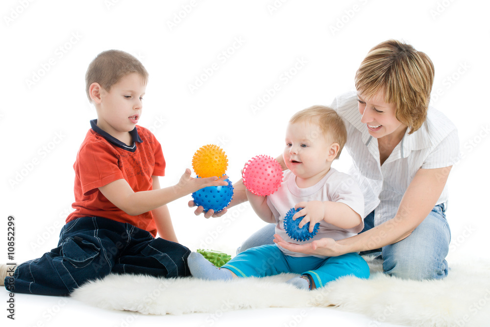 Mother with her sons enjoy with colorful balls Mother with her sons enjoy with colorful balls