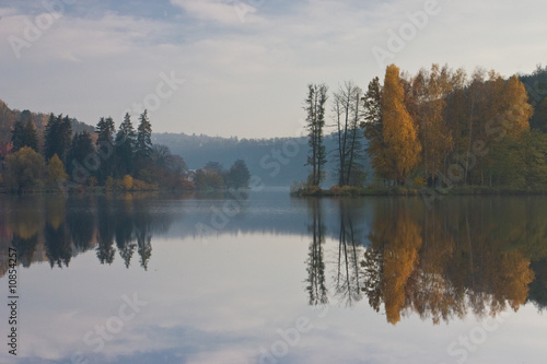 Autumn landscape of river and bright trees