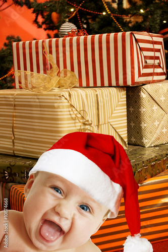 baby santa  with present boxes photo