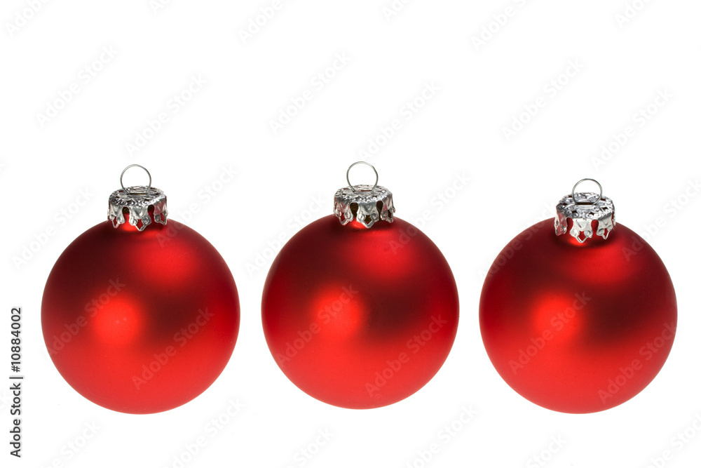 three red christmas baubles isolated on white background three red christmas baubles isolated on white background