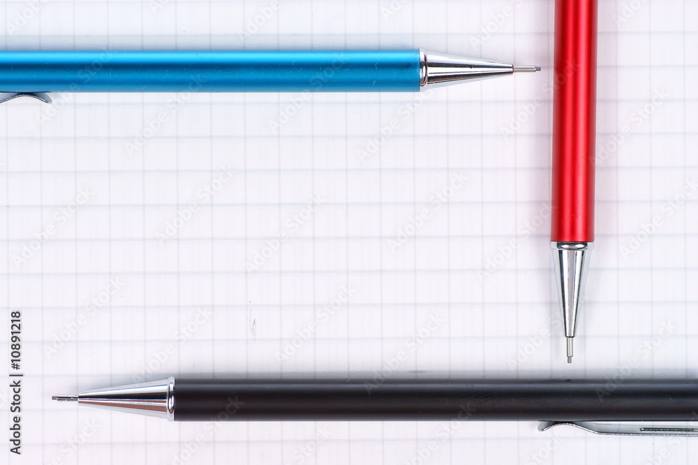 empty page of notebook and black, red, blue pencil empty page of notebook and black, red, blue pencil