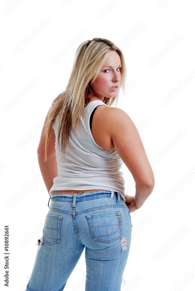 Sexy female in torn jeans looking over her shoulder Sexy female in torn jeans looking over her shoulder