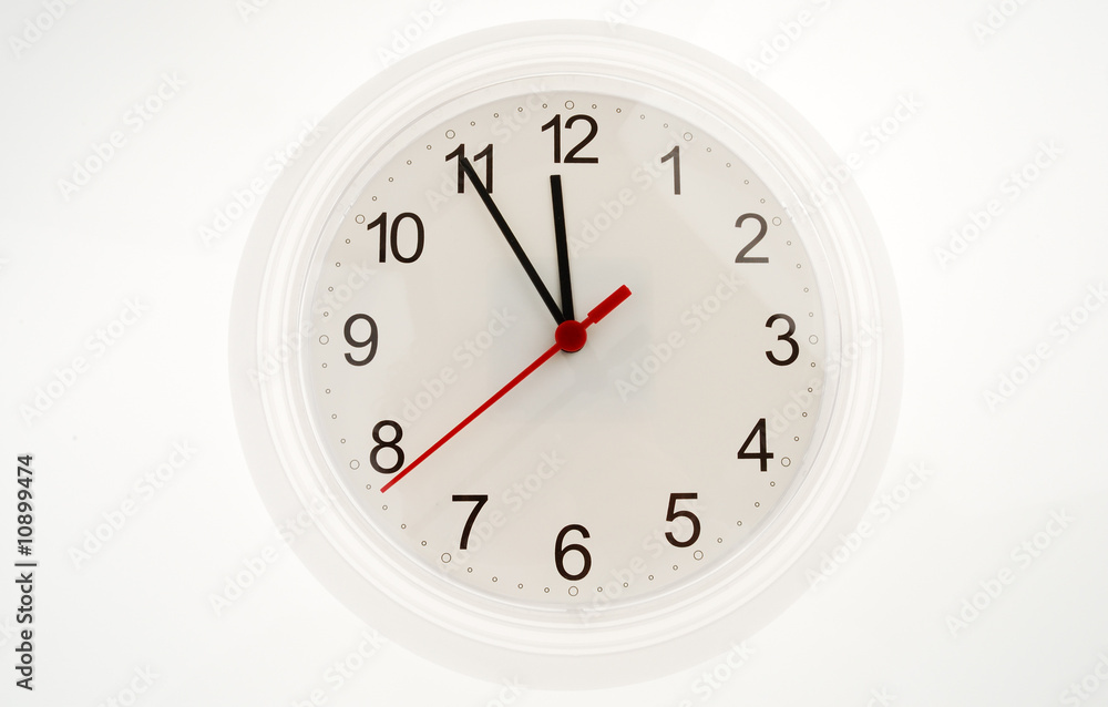 Wall clock showing five to twelve Wall clock showing five to twelve