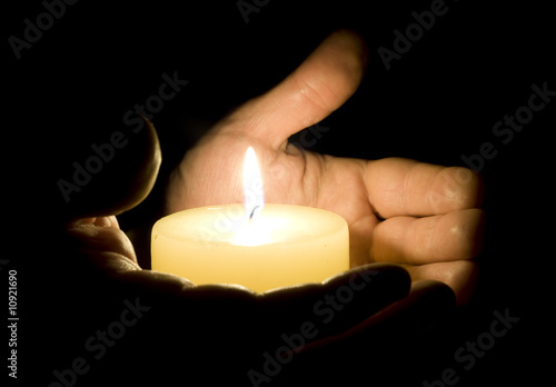 Human hands holding candle