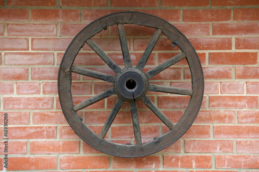 Old Wagon Wheel on brick Wall