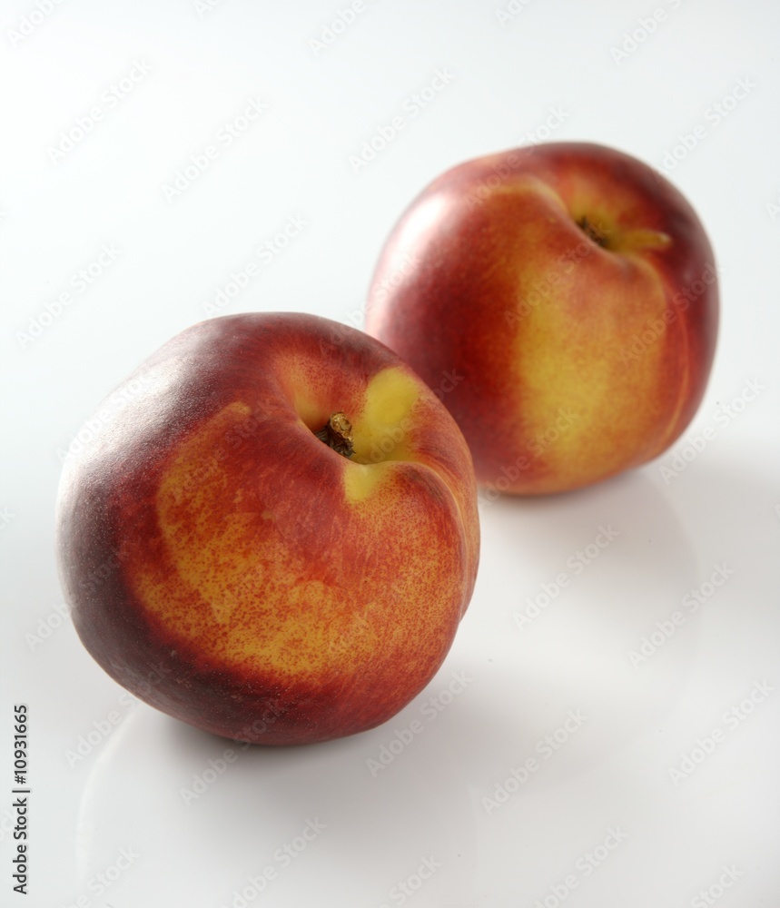 Two red peaches in white background Two red peaches in white background