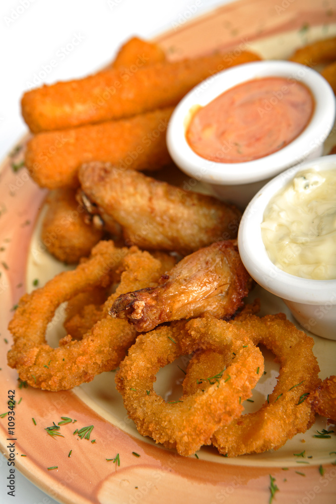 Rings of a squid, fish sticks, chicken hips with sauce. Rings of a squid, fish sticks, chicken hips with sauce.