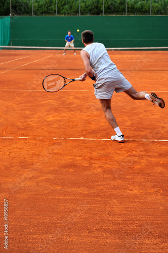 One man play tennis outdoors © .shock