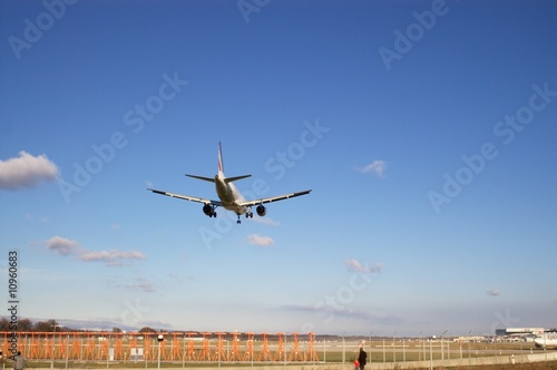 jet airplane landing on runway in blue sky