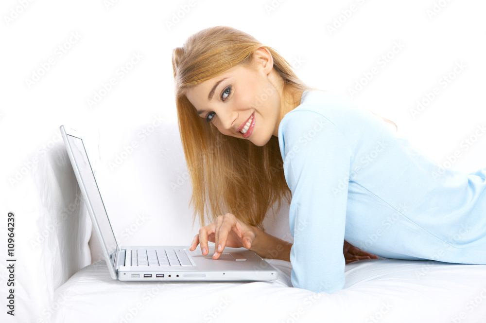 Young woman sitting on couch and working on laptop Young woman sitting on couch and working on laptop