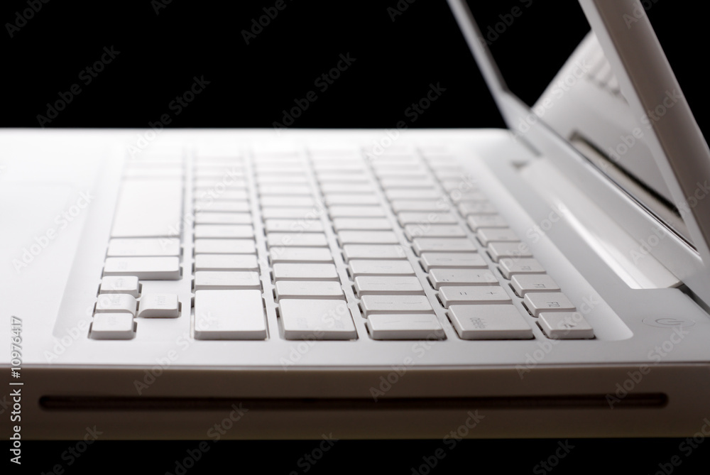 Open white laptop on a black background