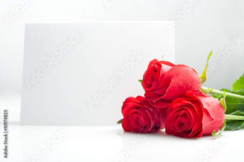 three roses with blank paper card