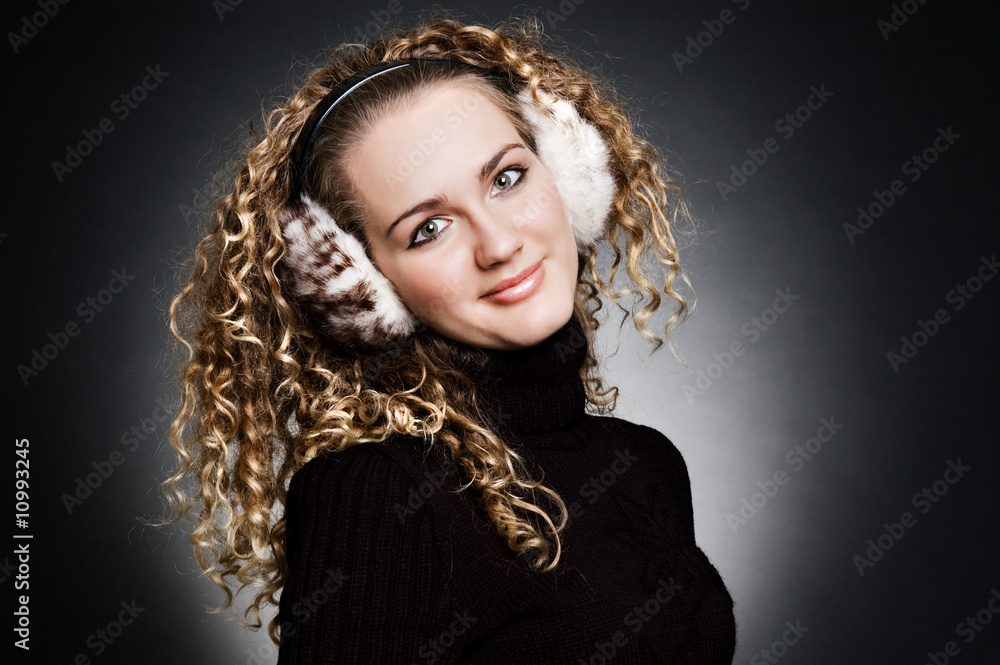 smiley young girl in fur headphones smiley young girl in fur headphones