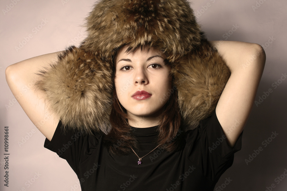 Portrait of the girl in a fur cap. Portrait of the girl in a fur cap.