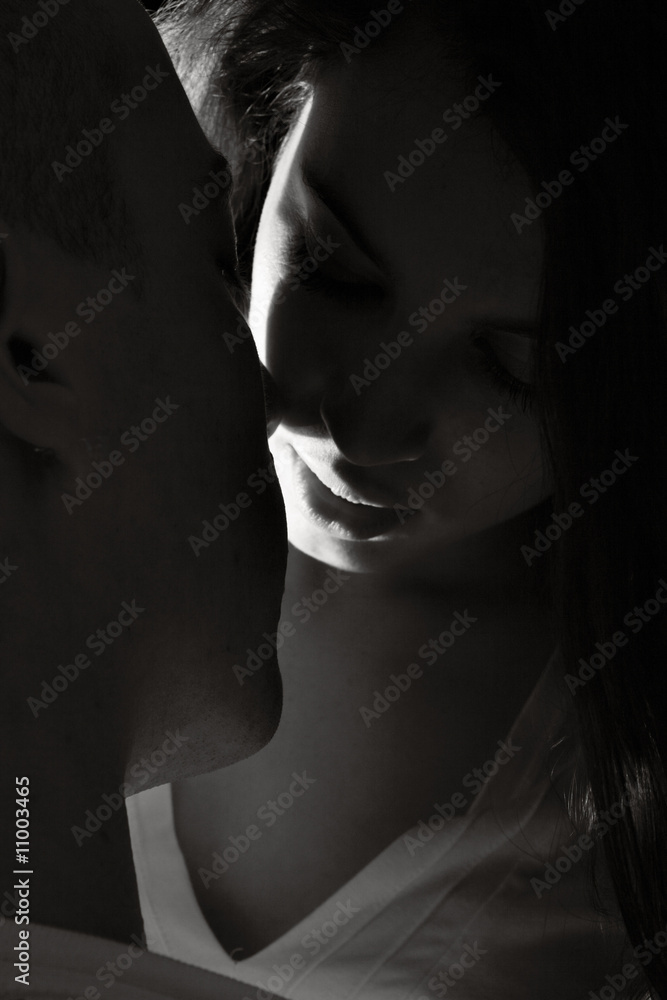 Young couple who are in love black and white with a ray of light Young couple who are in love black and white with a ray of light