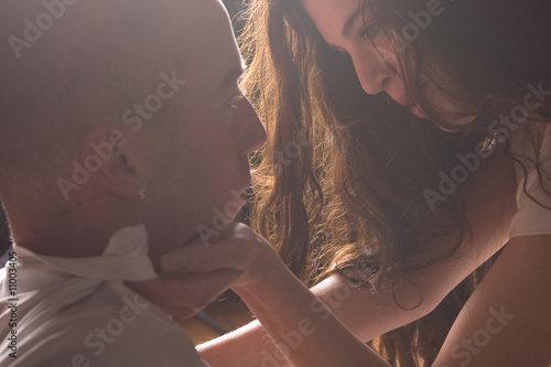 Loving couple in bright light passionately loving each other photo