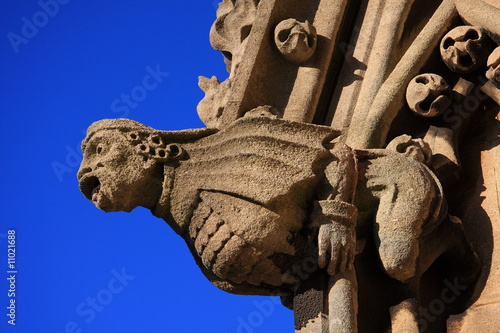 Close up shot of a church gargoyle against blue sky