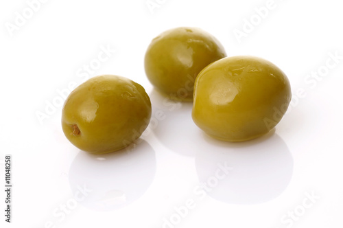 Green olives on white plate