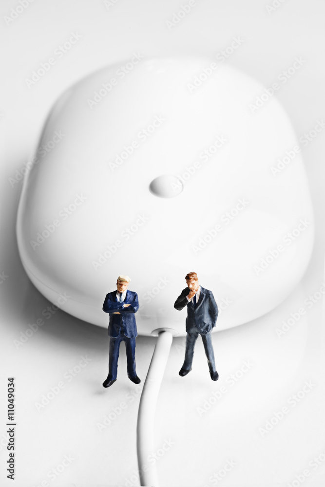 Obraz premium Businessman figurines placed with a computer mouse