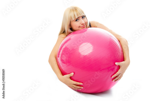 beautiful blond girl embracing a fitness ball